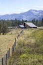 Fence leads to old barn in Montana Royalty Free Stock Photo