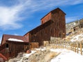 Fence Leads To Old Mining Building In Winter At Idahoâs Bayhorse
