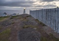 Fence and Lighthouse on the Atlantic Coast Royalty Free Stock Photo