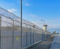 Fence line with barbed wire at a prison Royalty Free Stock Photo