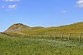 Fence line leading to ranch land pasture buttes