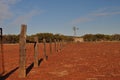 Fence line and windmill in outback australia Royalty Free Stock Photo