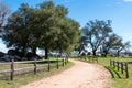 Fence-Lined Trail Curves Through Wooded Area in the Country Royalty Free Stock Photo