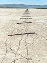 Fence lying flat on the playa Royalty Free Stock Photo