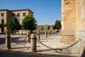 Fence made of natural stone pillars with metal chains embedded in the Cathedral of Ciudad Rodrigo, Salamanca, Spain Royalty Free Stock Photo
