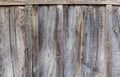 Fence made of rough old unpainted wooden boards Royalty Free Stock Photo