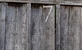 Fence made of rough old unpainted wooden boards with the number 7 painted on it Royalty Free Stock Photo