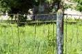 Fence made of rusty metal rods. Very old and rusty. The background is blurred (green grass). Royalty Free Stock Photo