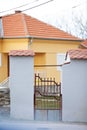 A fence made of stone and large pillars with tiles on top Royalty Free Stock Photo