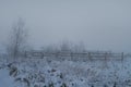 Fence in misty snow Royalty Free Stock Photo