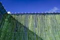 A fence with natural bamboo sticks to protect the privacy of a patio