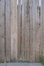 Fence from old weathered pine boards. Texture of natural aged wood. Woodworm holes, rusty nails. Creative vintage background Royalty Free Stock Photo