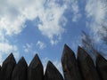 Fence palisade against the blue sky