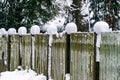 The fence posts are covered with white snow Royalty Free Stock Photo