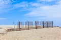Fence for protection of the dunes at the beautiful natural beach Royalty Free Stock Photo
