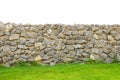 Fence real stone wall surface with cement on green grass field