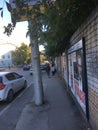 Fence and road in the street and passers-by