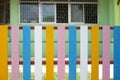 The fence of the school is in a colorful community. backgruond