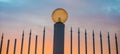 Fence with sharp peaks and street lamp in the evening. Street lamp on the background of a beautiful sunset sky Royalty Free Stock Photo