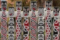 Fence with traditional Maori faces