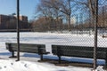 Fence and Empty Benches at a Snow Covered Park next to Public Housing in Astoria Queens New York during the Winter Royalty Free Stock Photo