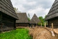 The fence between two wooden houses covered with hay, Maramures Village Museum, Romania