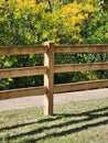 Fence on White Rock Creek Trail in Dallas with Trees in Autumn Colors in the Background Royalty Free Stock Photo