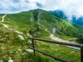 The fence wood logs in the mountains of Monte Baldo in Malcesine in Italy in a green meadow Royalty Free Stock Photo