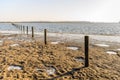 Fence of wooden poles and barbed wire in a flooded area Royalty Free Stock Photo