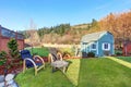 Fenced back yard with blue barn shed. Royalty Free Stock Photo