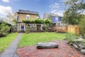 Fenced backyard with lawn, covered walkway and open terrace