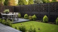 Fenced backyard. View of lawn and blooming flower beds