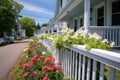 a fenced cape cod with porch displaying flower boxes Royalty Free Stock Photo