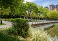 Fenced footpath at waterside in modern city at sunny summer noon