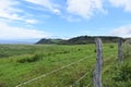 Fenced green rolling hill ranch landscape along the road to Hana on the island of Maui, Royalty Free Stock Photo