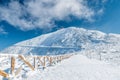 Fenced hiking path to Snezka mountain on a sunny day in winter, Giant mountains Krkonose, Czech republic Royalty Free Stock Photo