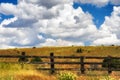 Fenced hill pasture under cloudy skies Royalty Free Stock Photo