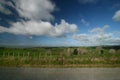 Scenic rural landscape of pastureland with wood posts and wired fence, blue sky and dramatic clouds in Waitomo, New Zealand