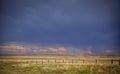 Dramatic storm clouds over a ranch pasture