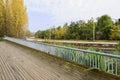 Fenced plank-paved footbridge in cloudy winter afternoon