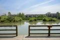 Fenced and planked lake shore in countryside on sunny summer day