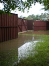 Fenced property during a deluge after a heavy rainfall