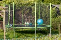a fenced trampolin for children in a garden, there are some balls in it Royalty Free Stock Photo