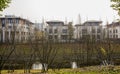 Fenced villas along rivulet in sunny winter afternoon