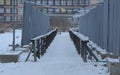 Fenced wooden passage between new buildings in winter