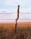 Barb wire and wood fence post on the Kansas prairie