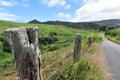 Fencepost from a green hilly ranch along the Road to Hana on the island of Maui, Hawaii Royalty Free Stock Photo