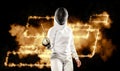 Fencer fencing on the black background with yellow neon lights. Template for bookmaker ads with copy space. Mockup for