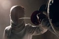 Fencer with fencing sword. Fencers duel concept. Royalty Free Stock Photo