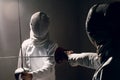 Fencer with fencing sword. Fencers duel concept. Royalty Free Stock Photo